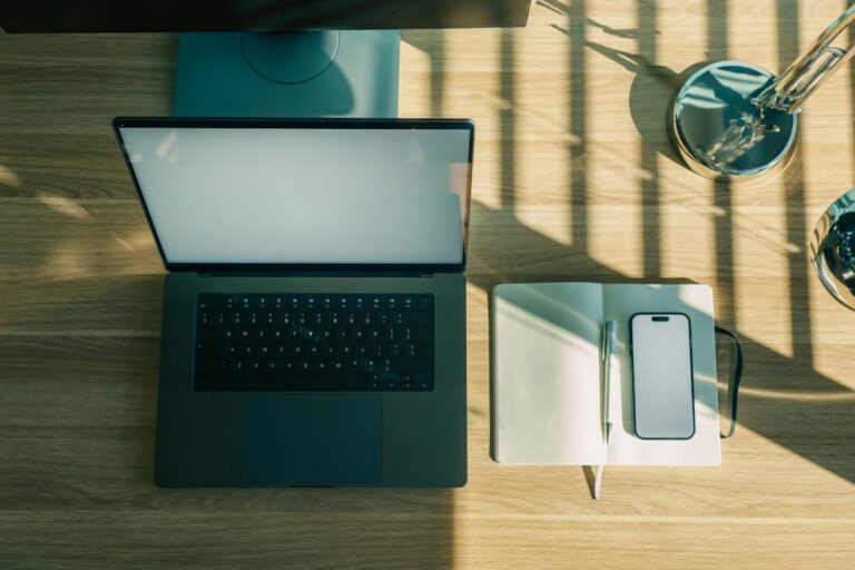 Illustrative smartphone and laptop workspace for ElevenLabs WhatsApp Business AI agent setup